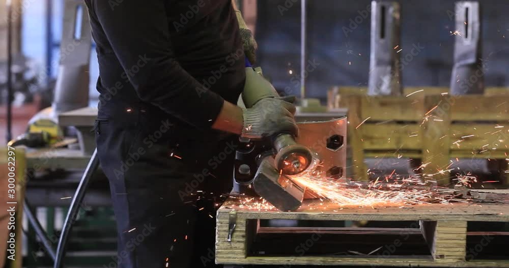 Sparks during cutting of metal angle grinder. A lot of glowing sparks flies around the rotating disk of the grinder. Sparkling background. Metal cutting Sparks during cutting of metal angle grinder. A lot of glowing sparks flies around the rotating disk of the grinder. Sparkling background. Metal cutting