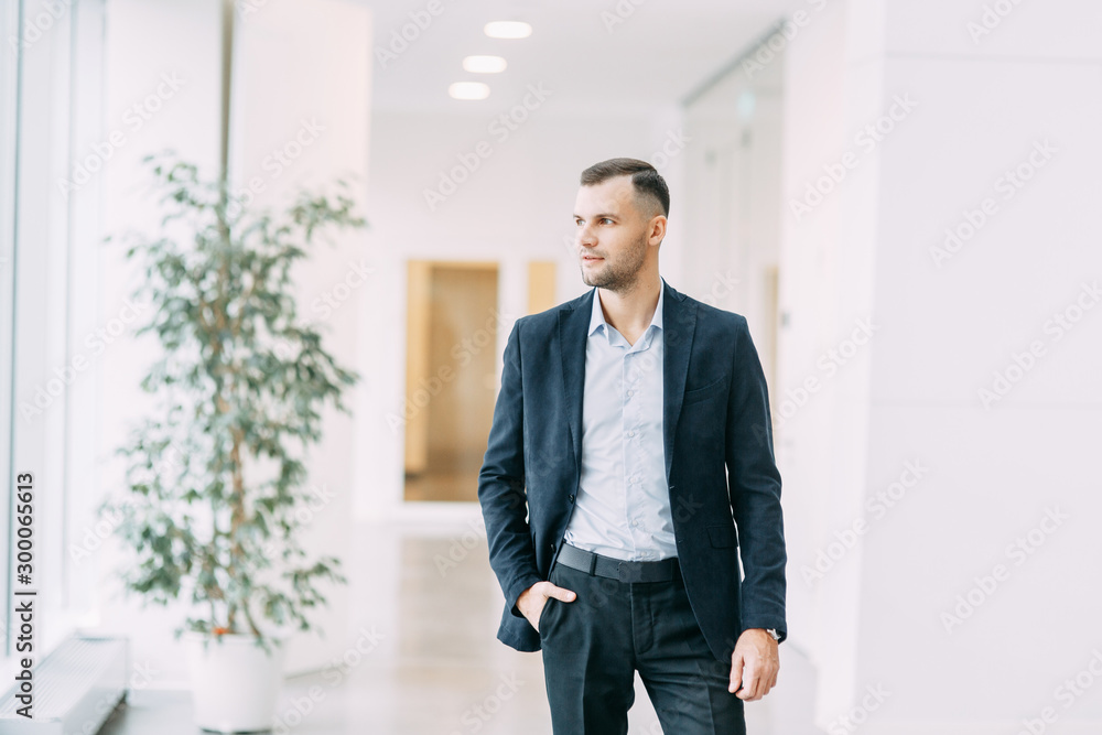 Walking around the business center. Portrait of a young successful man in motion. Walking around the business center. Portrait of a young successful man in motion.
