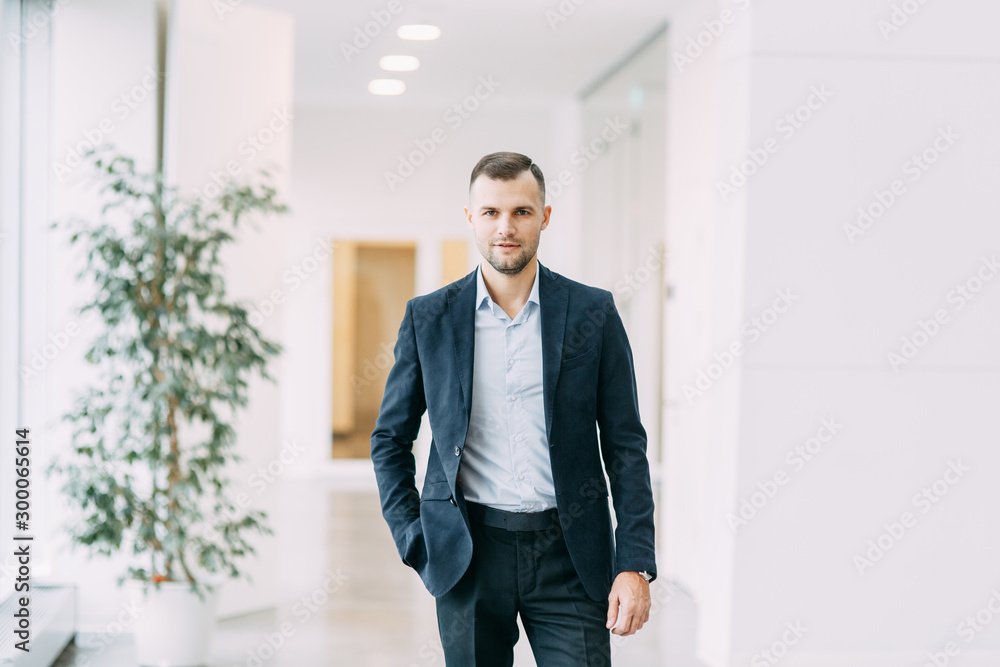 Walking around the business center. Portrait of a young successful man in motion. Walking around the business center. Portrait of a young successful man in motion.