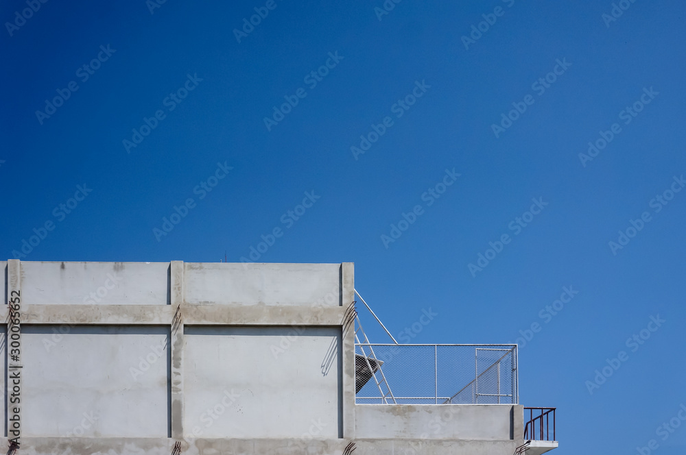 Constructions made from concrete with a bright blue background, suitable for making wallpaper
