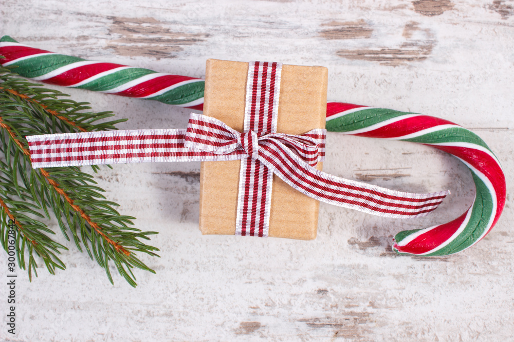 Gift for Christmas or Valentines, candy cane and spruce branches Gift for Christmas or Valentines, candy cane and spruce branches