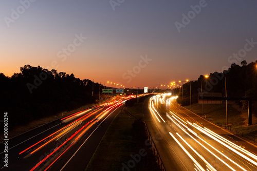 Peak hour traffic long exposure growing during golden hour. © timallenphoto