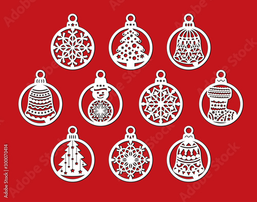 Set of laser cut template of Christmas balls with snowflake, bell, snowman, sock. Xmas tree decoration for paper cut out. Openwork silhouette with lace ornament. Vector illustration on red background.