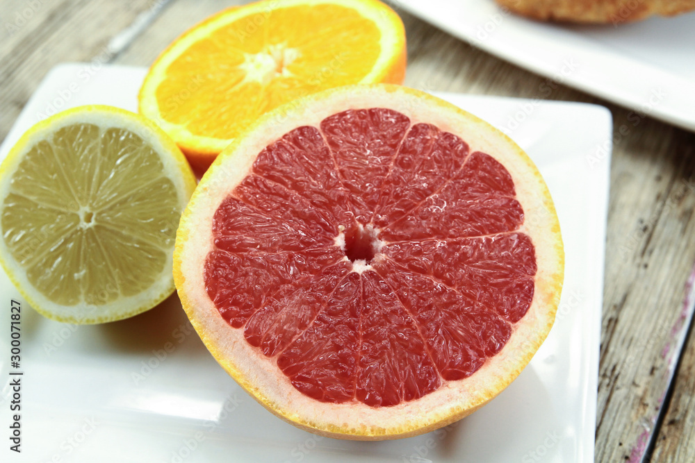 citrus fruits, oranges, grapefruit and lemon on a table citrus fruits, oranges, grapefruit and lemon on a table