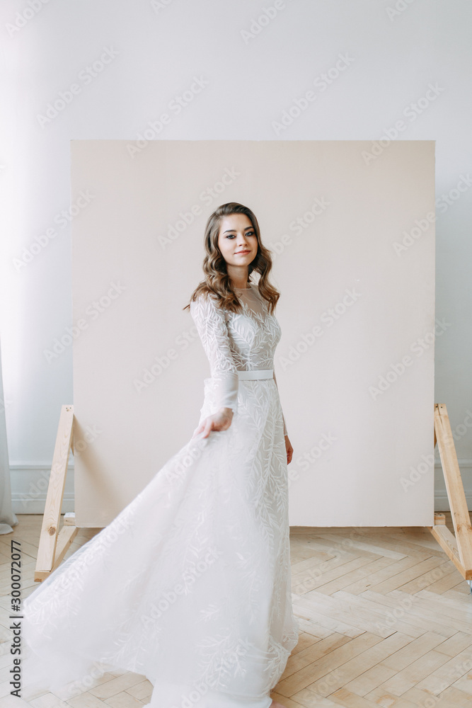 European wedding in the style of fine art. Modern bride in white interior Studio.