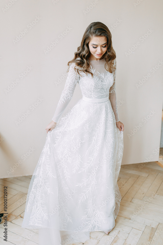 European wedding in the style of fine art. Modern bride in white interior Studio. European wedding in the style of fine art. Modern bride in white interior Studio.