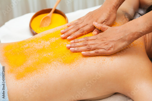 .Asian woman getting a salt scrub on her back beauty treatment in the health spa