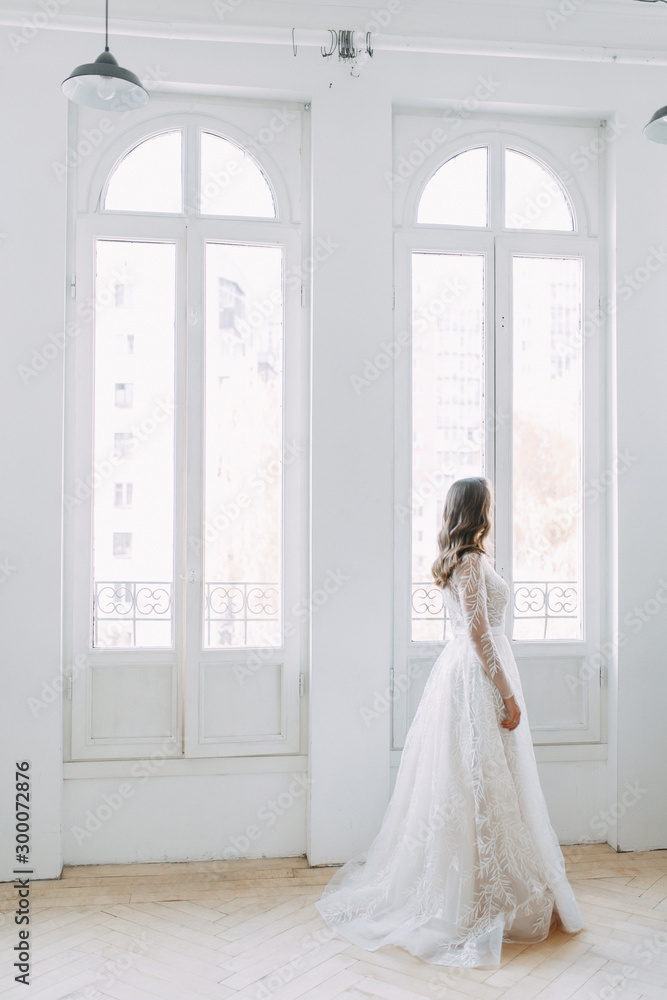 Beautiful girl in white dress, European wedding. Air and light photo shoot of the bride.