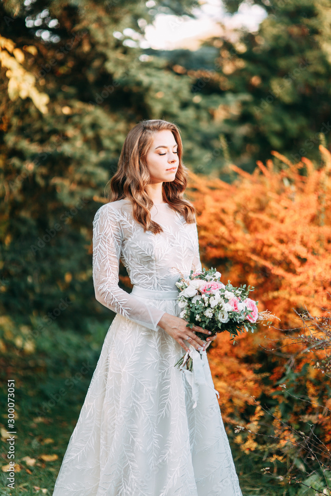 Autumn wedding in European style. Beautiful bride in white dress in the Park. Autumn wedding in European style. Beautiful bride in white dress in the Park.