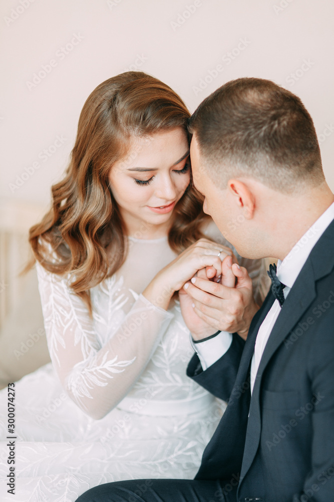 Stylish wedding in European style. Beautiful Apara sits in a large window. Stylish wedding in European style. Beautiful Apara sits in a large window.