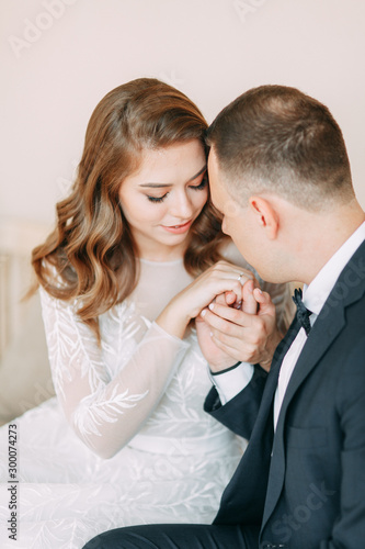  Stylish wedding in European style. Beautiful Apara sits in a large window. © pavelvozmischev