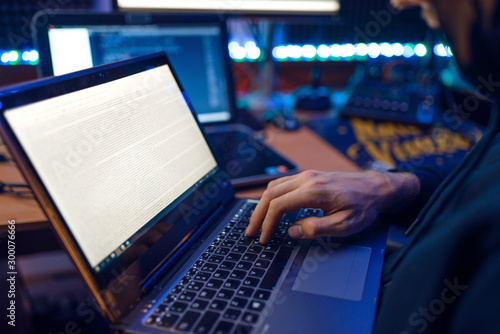Hacker in hood shows thumbs up, network criminal