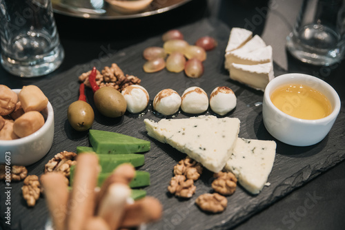 Festive table with food. Cheese and nuts © Artem