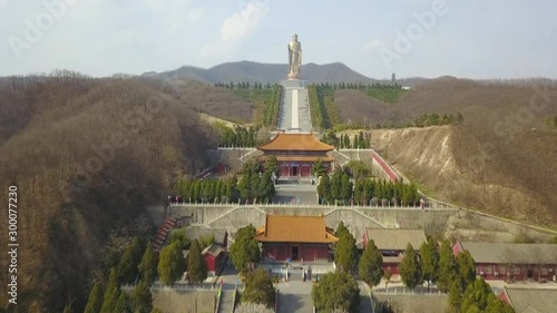 View from the side of Spring Temple Buddha and the temple at it's feet in Lushan County, Henan, China (aerial photography) photo