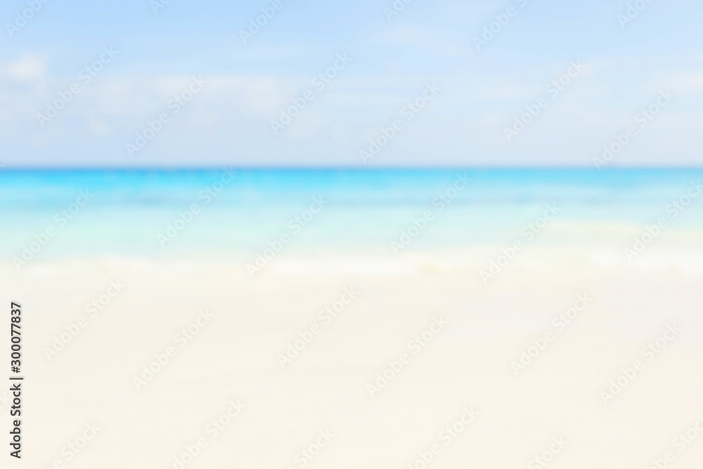 Blur summer white sand beach with sparkling sea water Blur summer white sand beach with sparkling sea water