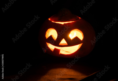 Halloween pumpkins glow in a dark room