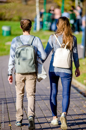 Guy and girl walking in the autumn Park 