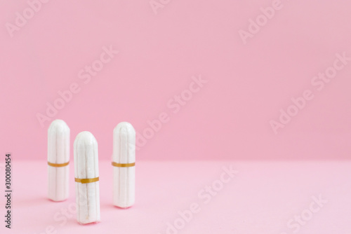 white tampons on pink background. woman period concept. photo