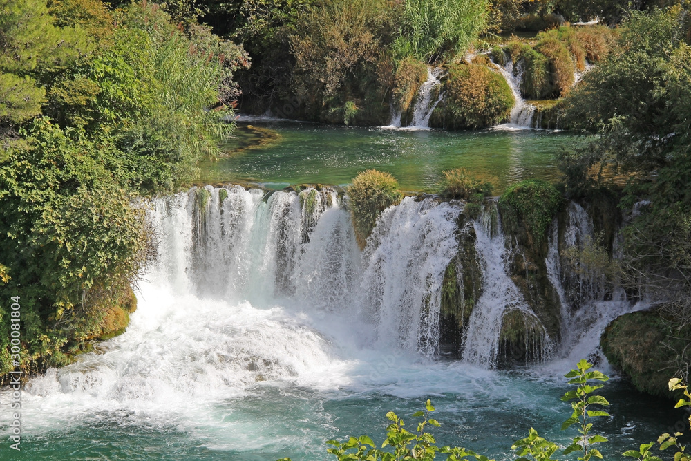 Krka National Park with a beautiful Skradinski Buk waterfall in early autumn, famous travel destination in Dalmatia of Croatia. Europe. Krka National Park with a beautiful Skradinski Buk waterfall in early autumn, famous travel destination in Dalmatia of Croatia. Europe.