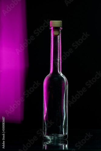 empty glass bottle on a black background