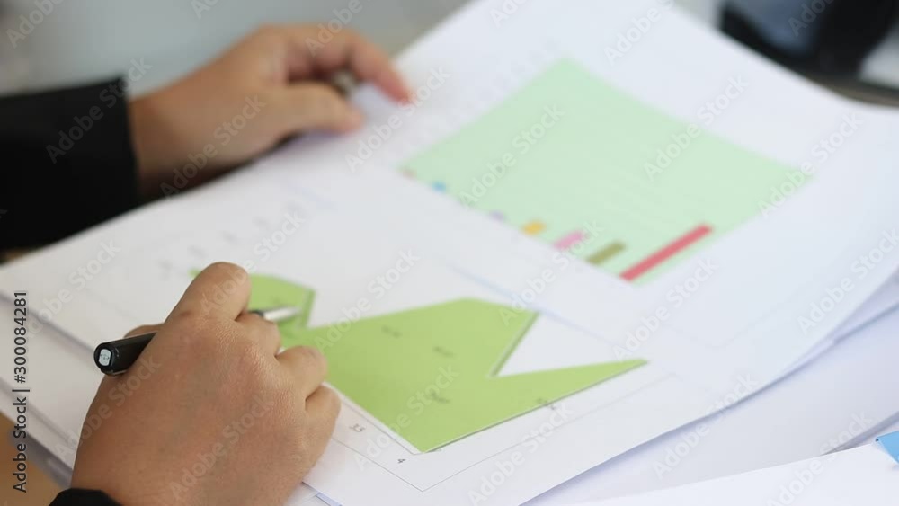Data analysis and project management concept. Asia businesswoman analyzing statistics and working with business report using pencil for check data in order to improve their performance. Data analysis and project management concept. Asia businesswoman analyzing statistics and working with business report using pencil for check data in order to improve their performance.