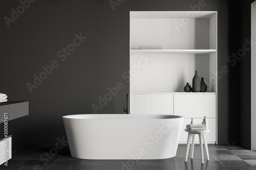 Gray bathroom interior with tub and cabinet