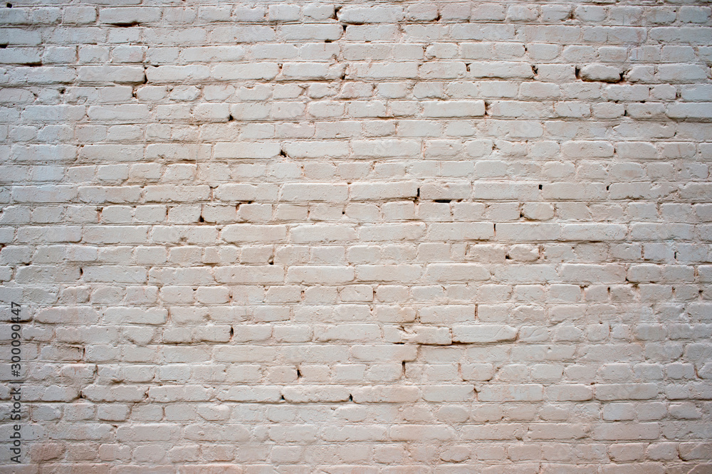 Obraz premium White painted brick wall with beige shade of color and volumetric shadows. Textured background