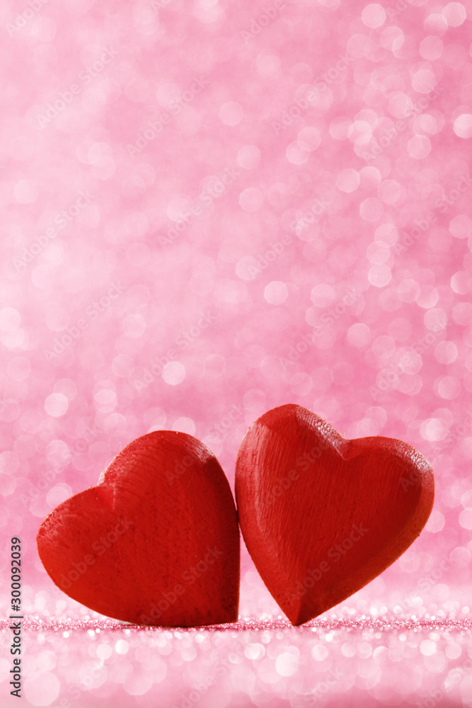 Fototapeta premium Two red hearts on bokeh background