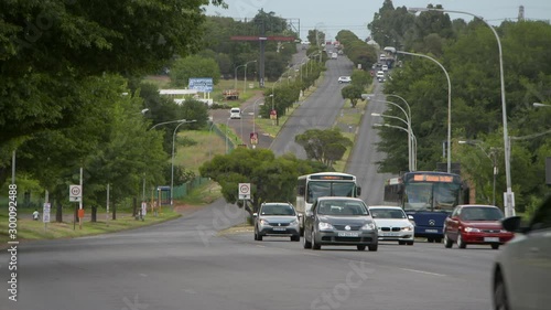 Automobiles speeding on highway amidst trees in city - Johannesburg, South Africa