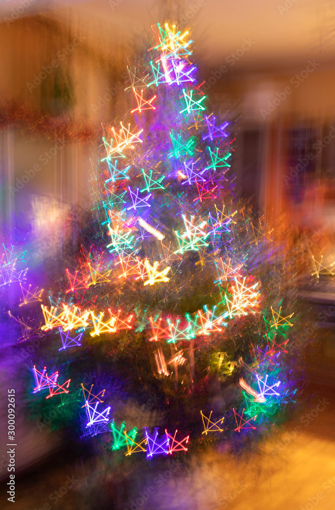 Abstract christmas neon background. Blurred garlands of lot of multicolored neon glowing stars on Christmas tree.
