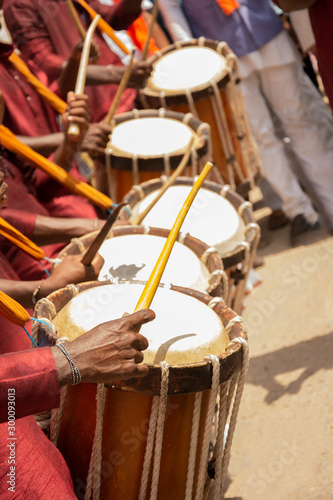 Close up of Group of People hands performing Indian art form Chenda or chande a cylindrical percussion playing during festival. photo
