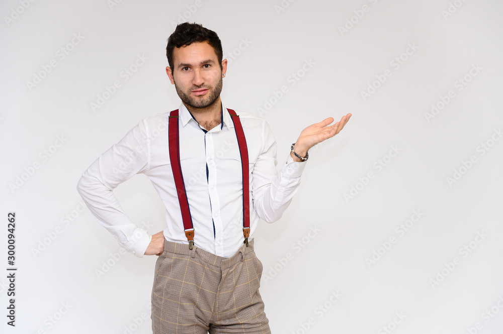 Men's fashion concept. Portrait of a handsome male model with perfect body wearing a white shirt posing on a white background. Black hair. Close Studio Shot Men's fashion concept. Portrait of a handsome male model with perfect body wearing a white shirt posing on a white background. Black hair. Close Studio Shot