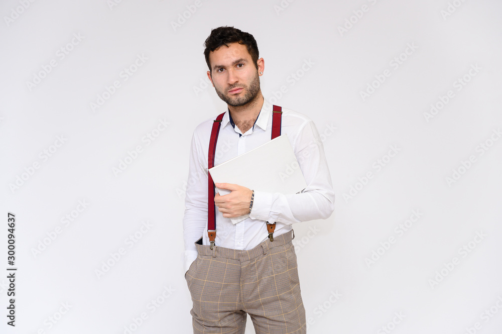 Men's fashion concept. Portrait of a handsome male model with a folder in his hands with a perfect body wearing a white shirt, posing on a white background. Black hair. Close Studio Shot Men's fashion concept. Portrait of a handsome male model with a folder in his hands with a perfect body wearing a white shirt, posing on a white background. Black hair. Close Studio Shot