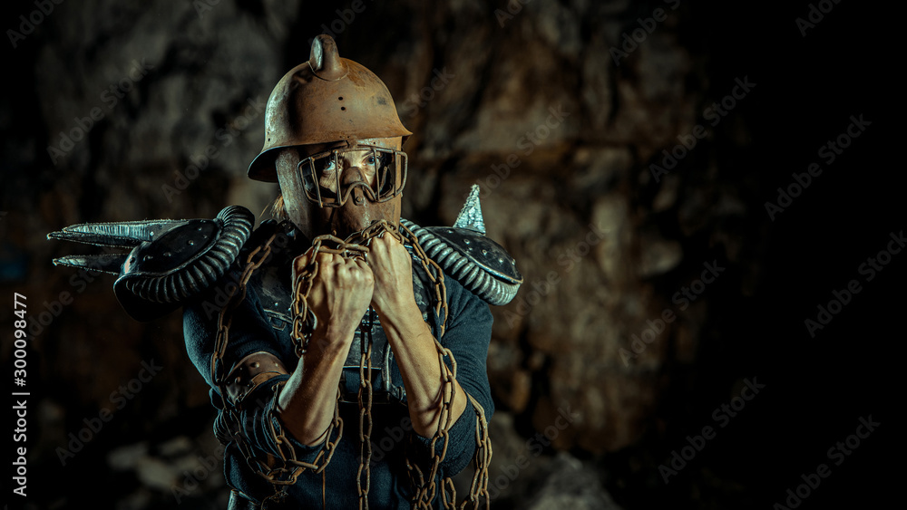 Post-apocalyptic woman in the rusty helmet with a chain in hands on the  dungeon background. Nuclear post-apocalypse time. Life after doomsday Stock  Photo | Adobe Stock