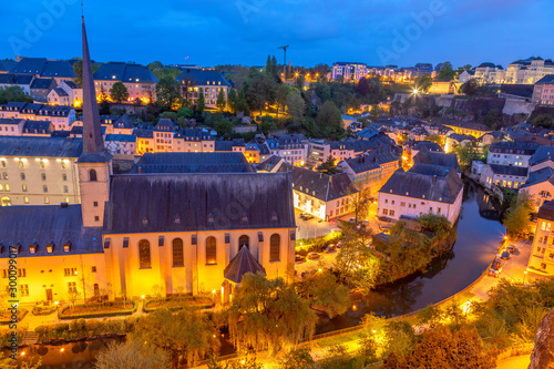 Alzette river bend with Saint Jean Du Grund cathedral and row of the houses behind, Luxembourg city, Luxembourg