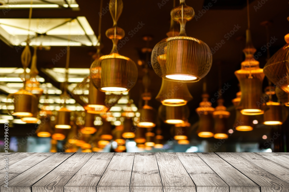 Image of wooden table in front of abstract blurred restaurant lights background. Image of wooden table in front of abstract blurred restaurant lights background.