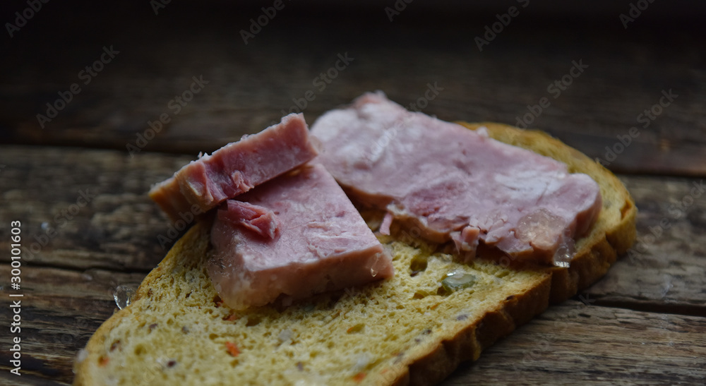bread gray with added cereals with ham on a wooden table bread gray with added cereals with ham on a wooden table