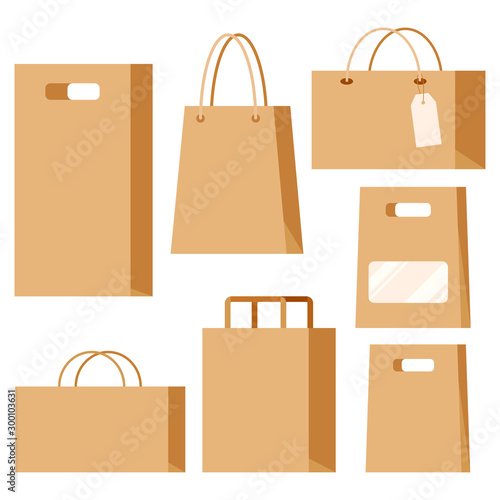 Set of empty kraft brown blank cardboard paper fashion packaging bags with handles isolated on white background