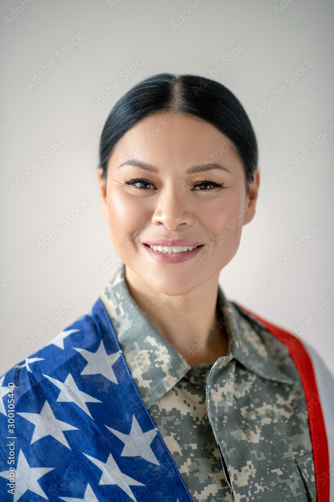 Excited Asian military woman smiling while feeling excited Excited Asian military woman smiling while feeling excited