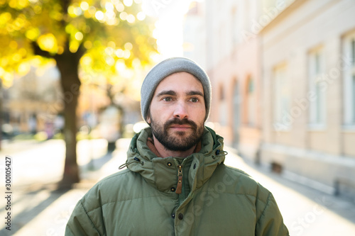 Portrait of man in jacket and beanie outdoor 