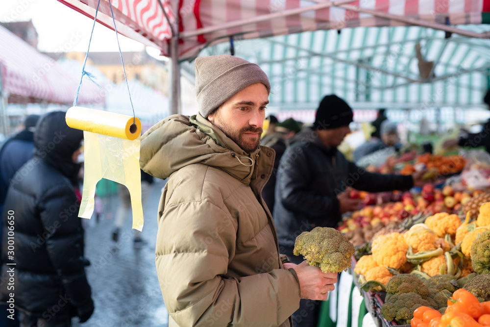 Man shopping for fruit and vegetables at market 