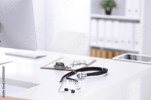 Stethoscope, prescription medical form lying on a table with pc computer. Medicine or pharmacy concept. Medical tools at doctor working table