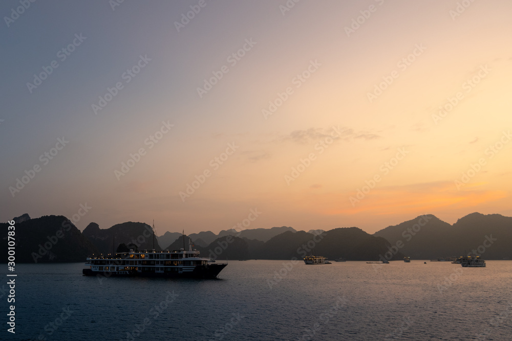 Fototapeta premium Ha Long Bay in Vietnam during a beautiful Sunset with calm, tranquil seas. Shot in Autumn 2019 from a cruise ship tour
