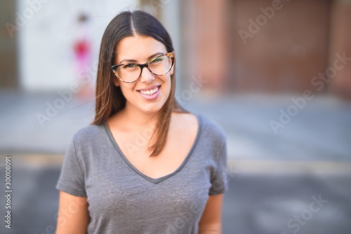 Free Download Young beautiful woman smiling happy and confident. Standing with smile on face at town street - GFXLoad