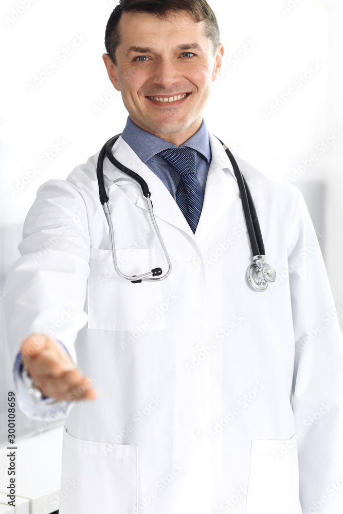 Doctor man cheerful smiling at camera, helping hand. Perfect medical service in clinic. Happy future in medicine and healthcare Doctor man cheerful smiling at camera, helping hand. Perfect medical service in clinic. Happy future in medicine and healthcare