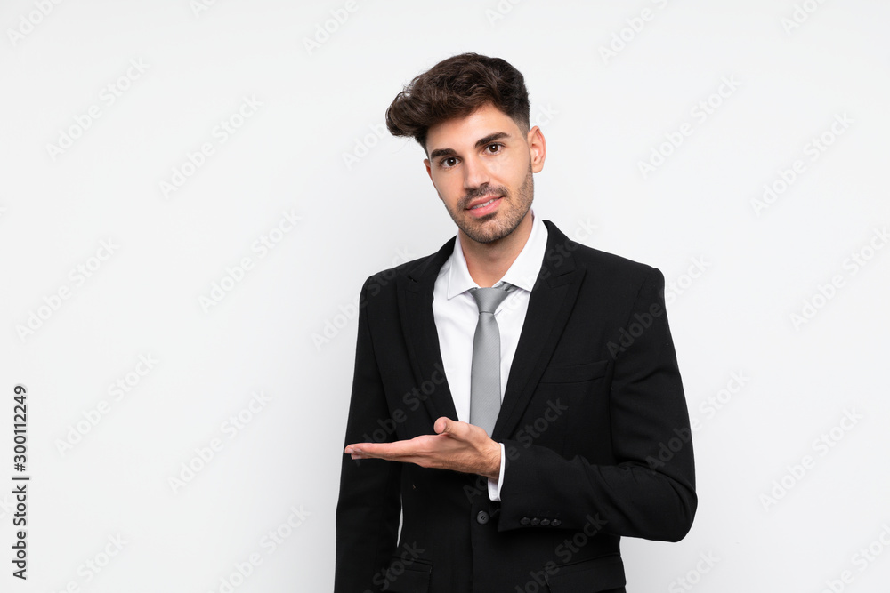 Young businessman over isolated white background extending hands to the side for inviting to come Young businessman over isolated white background extending hands to the side for inviting to come