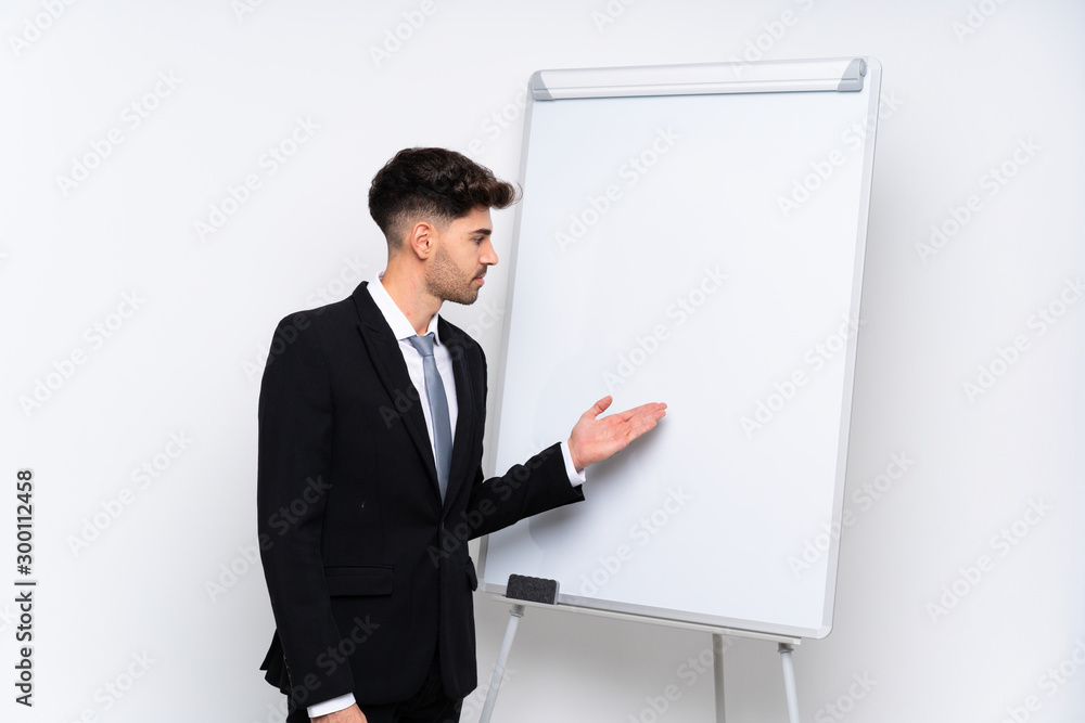 Young businessman giving a presentation on white board giving a presentation on white board Young businessman giving a presentation on white board giving a presentation on white board