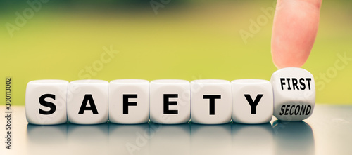 Hand turns a dice and changes the expression "safety second" to "safety first"