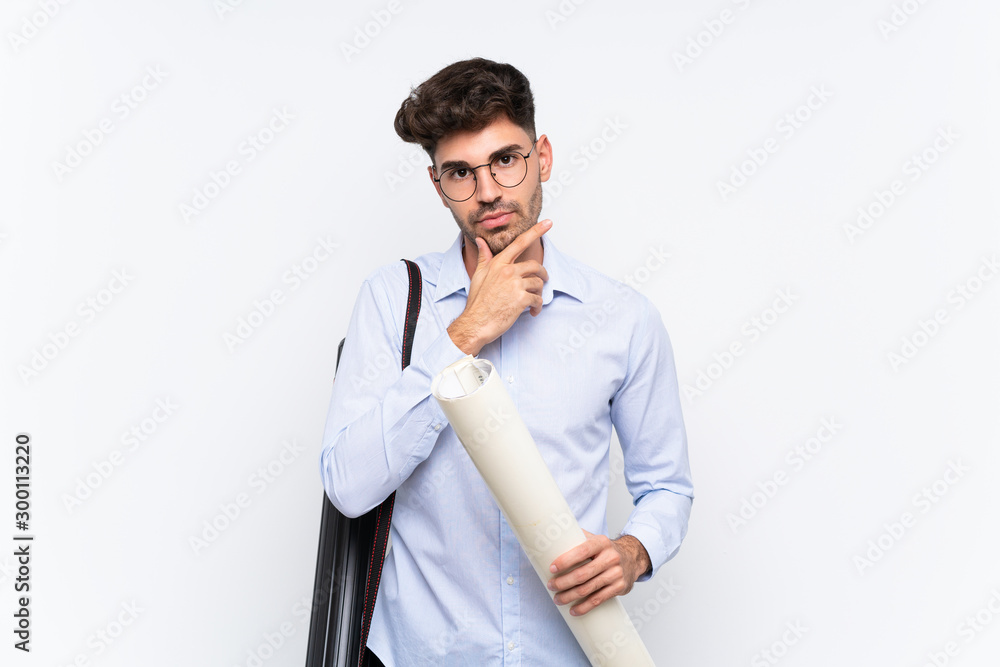 Young architect man over isolated white background thinking an idea Young architect man over isolated white background thinking an idea