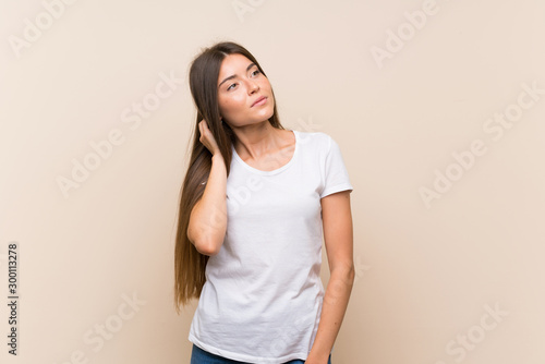 Pretty young girl over isolated background thinking an idea